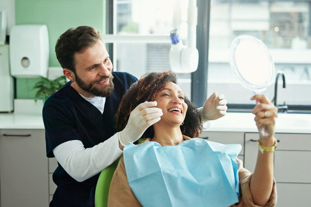 Happy patient and dentist celebrating results, highlighting advancements in dental devices.